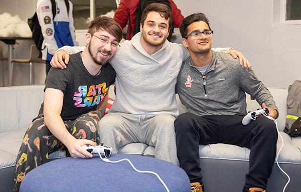 students playing video games in their dorm